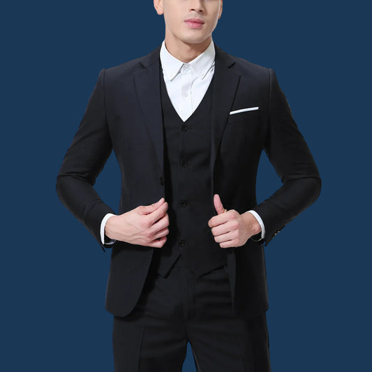 Man wearing a black suit with a white shirt on a white background