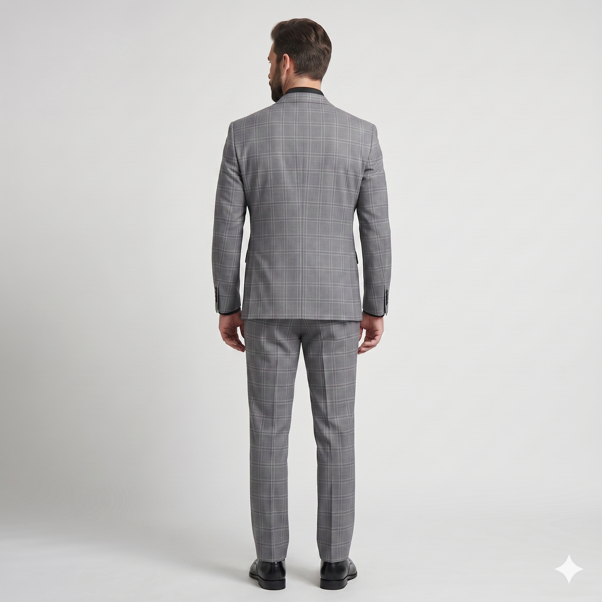 Man wearing a gray checkered suit on a white background