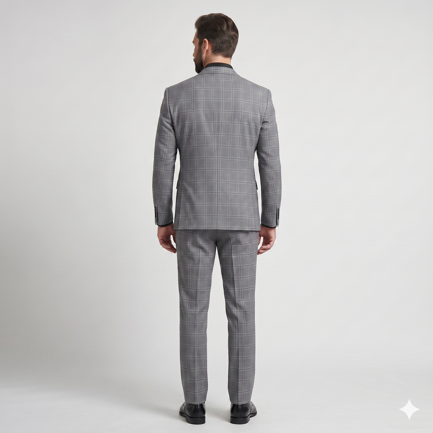 Man wearing a gray checkered suit on a white background
