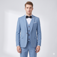 Man wearing a light blue pinstripe suit with a black bow tie on a white background