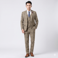 Man wearing a beige checkered suit with a white shirt and striped tie on a light gray background