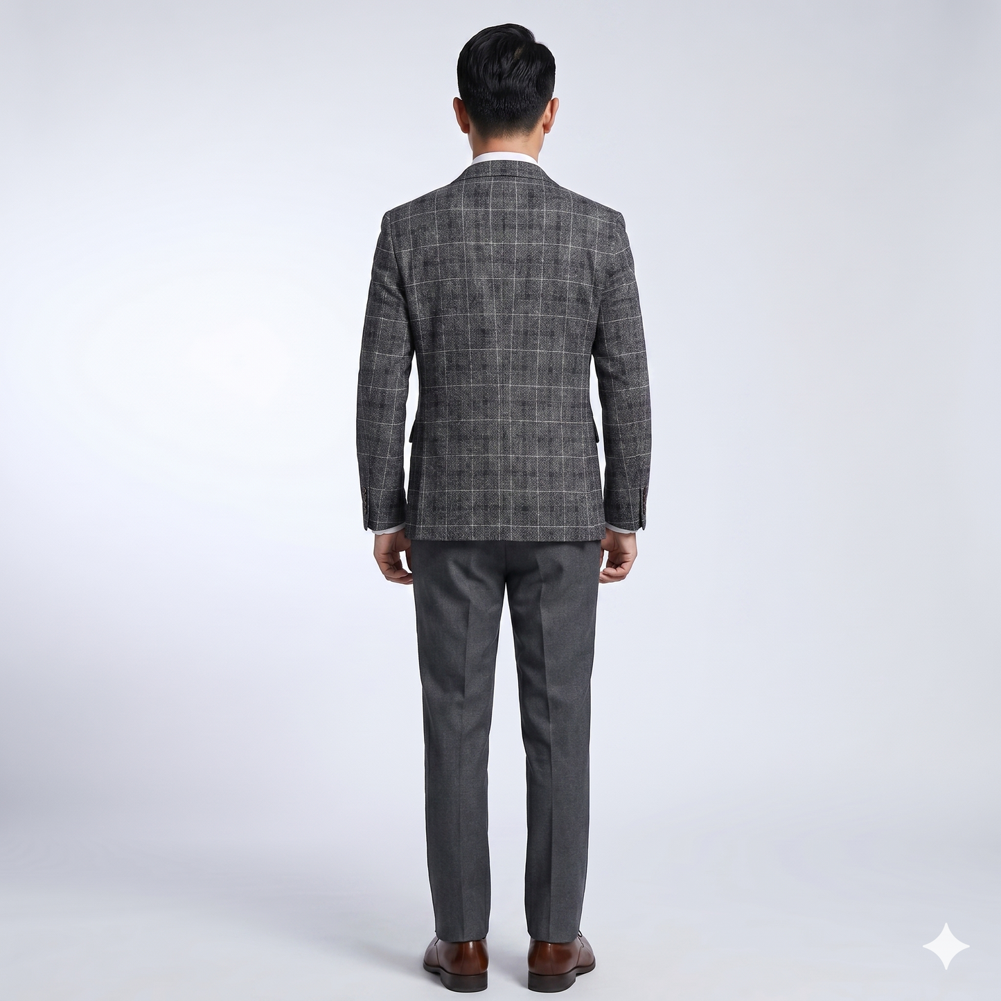 Man wearing a gray checkered suit on a white background