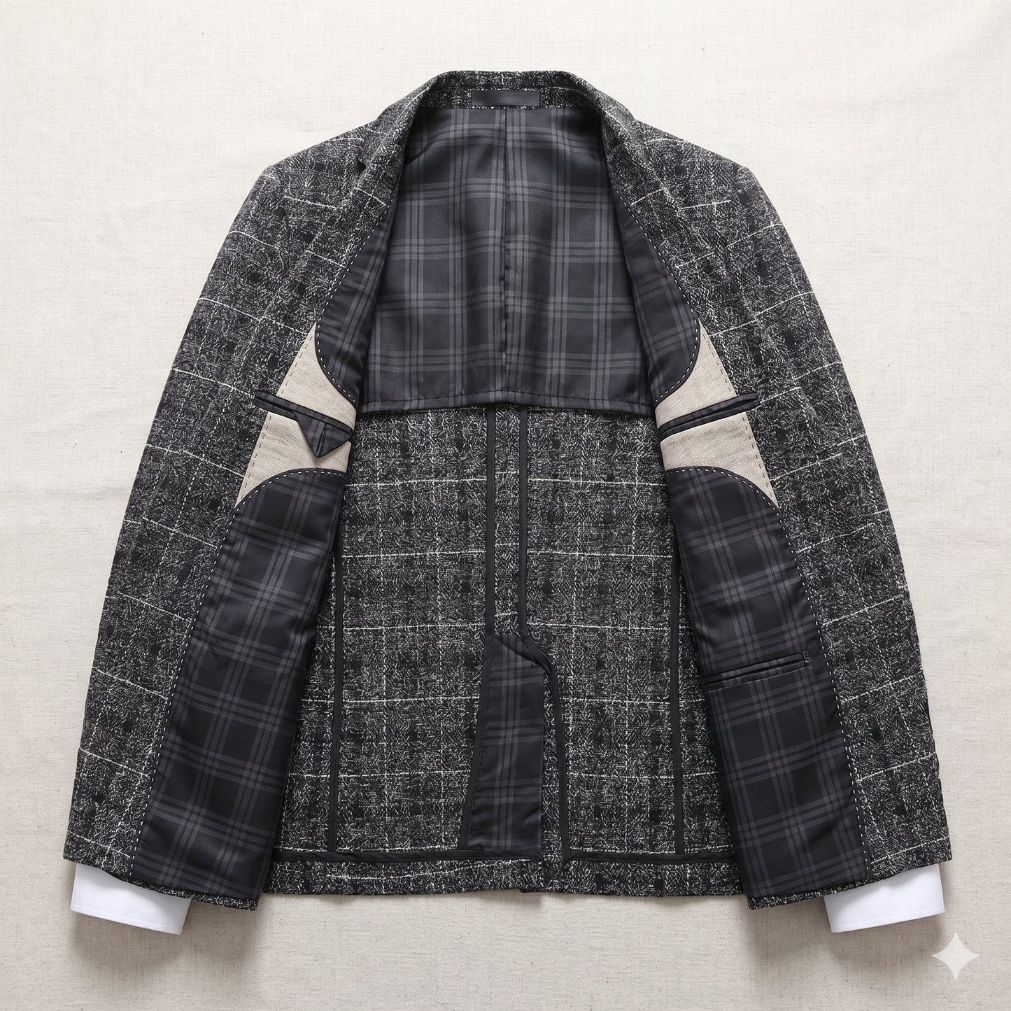 Gray checkered blazer with contrasting elbow patches on a light gray background