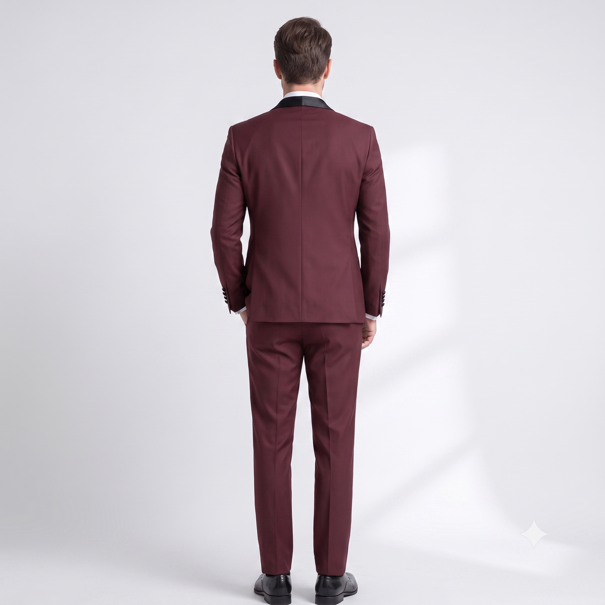 Man wearing a burgundy suit on a white background