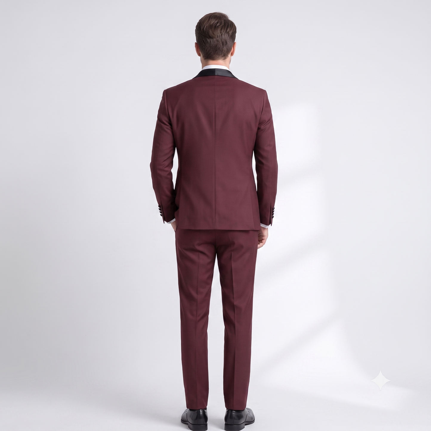 Man wearing a burgundy suit on a white background