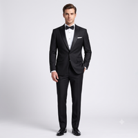 Man wearing a black tuxedo with a white shirt and black bow tie on a light gray background