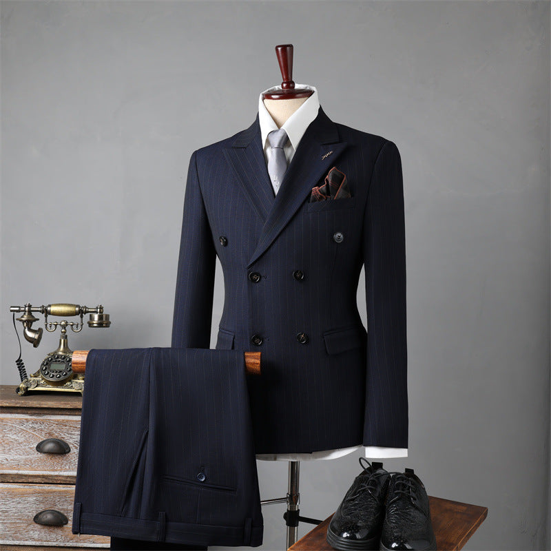 Navy blue suit on a mannequin with shoes and pocket square against a gray background